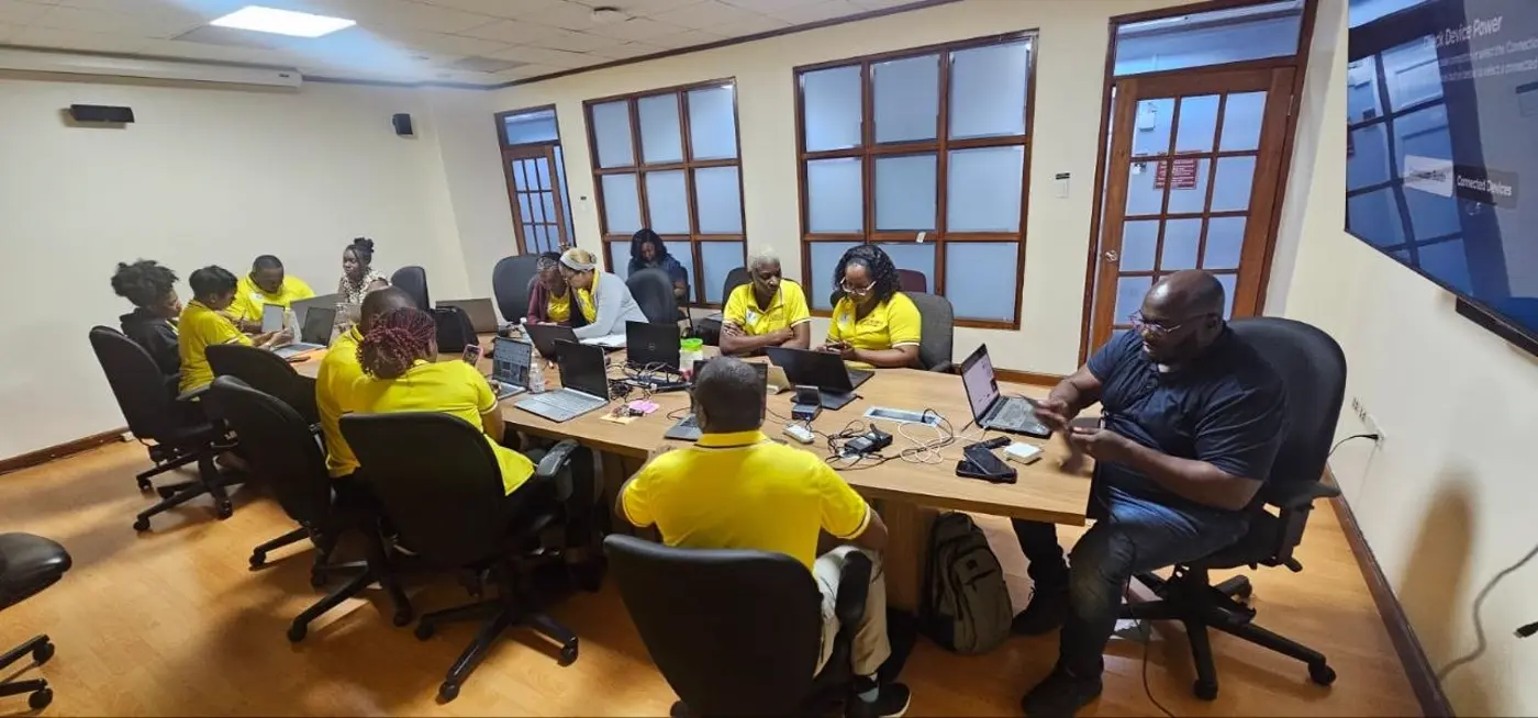 JPS workshop participants applying AI tools on laptops and phones during the August 2026 session